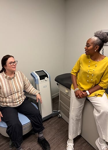 a woman sitting on BTL Emsella chair to strengthen pelvic muscles talking to dr aluko