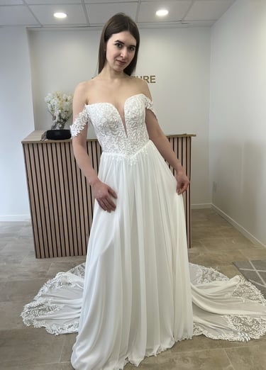 a woman in a white dress standing in a room