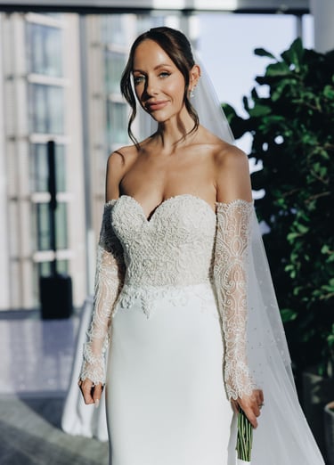 a bride in a white wedding dress with a veil