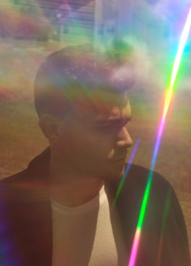 a man with a rainbow - colored light shining through a rainbow - colored light