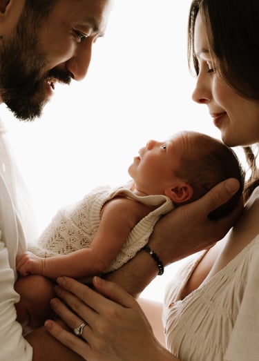 newborn looking. up at both parents, backlit natural light in Adelaide Hills studio