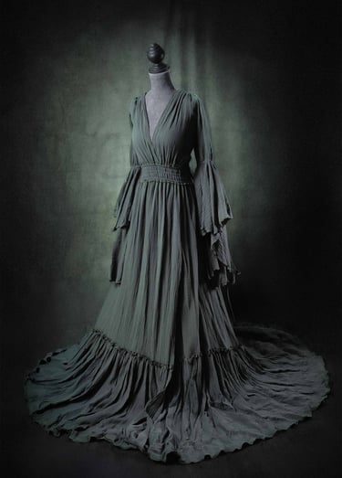 Elegant dark green boho maternity dress with bell sleeves and a flowing skirt on a mannequin.