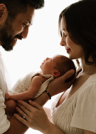 newborn looking. up at both parents, backlit natural light in Adelaide Hills studio