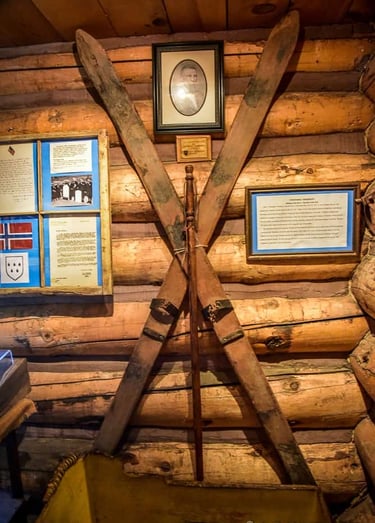 two telemark skis crossed and mounted on a log wall