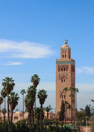 The famous Koutoubia Mosque tower in Marrakech, pictured against a blue sky