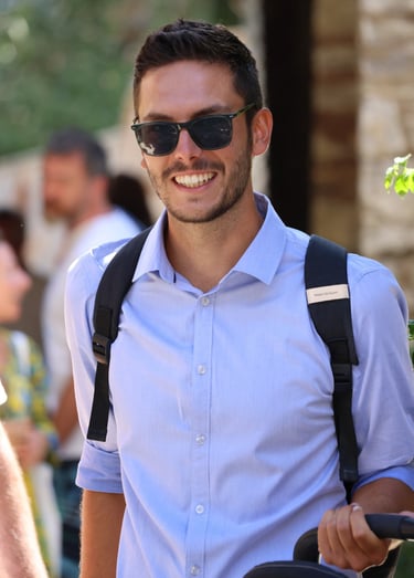 a man in a blue shirt and sunglasses