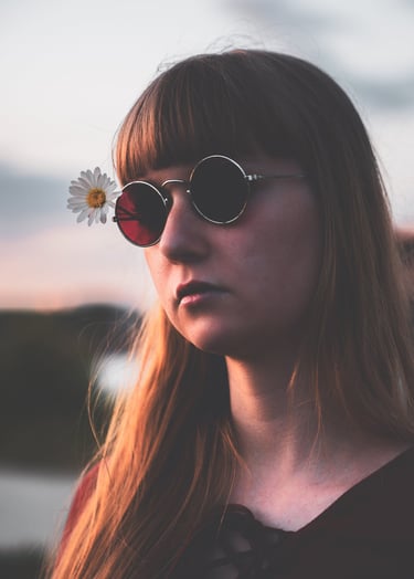 a woman with sunglasses on her face during sunset