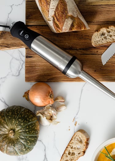Food product photography - a table with bread, soup and a blender