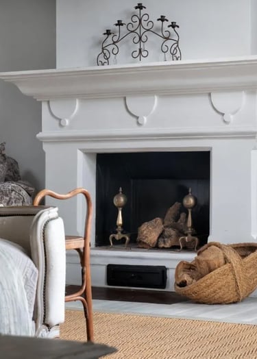 Fireplace with baskets and decor at Finca Santa Katerina