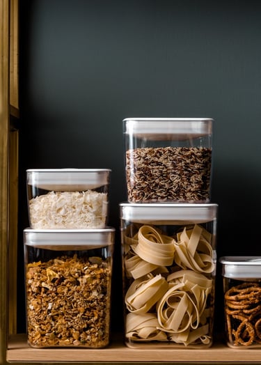 Food product photography - a shelf with several containers of food and nuts