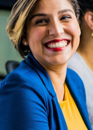 a woman sitting at a desk with a man and woman