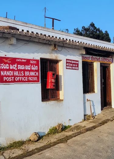 Tiny historic post office at the Nandi Hills summit, reflecting old-world charm amid misty hill surroundings near Bengaluru