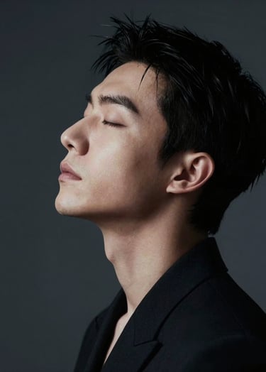 A sophisticated side profile photograph of a musician with eyes closed in reflection. The lighting is a soft off-white glow against a deep dark charcoal background, creating an elegant and understated atmosphere.