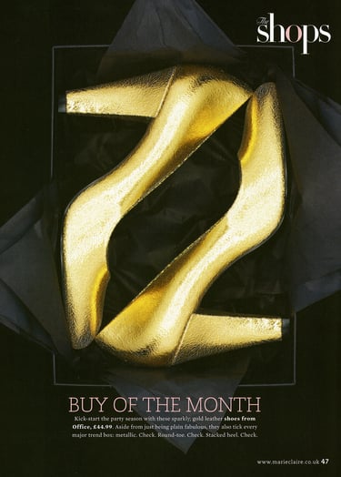 magazine page with gold shoes in a black box