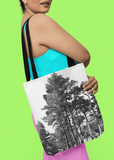 a woman in coloured clothing holding a tote bag