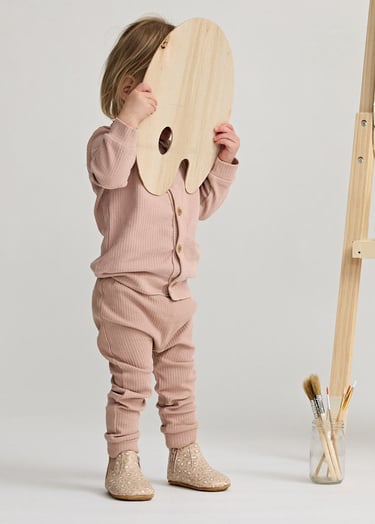 Fashion campaign photography - a little girl standing in front of a easel
