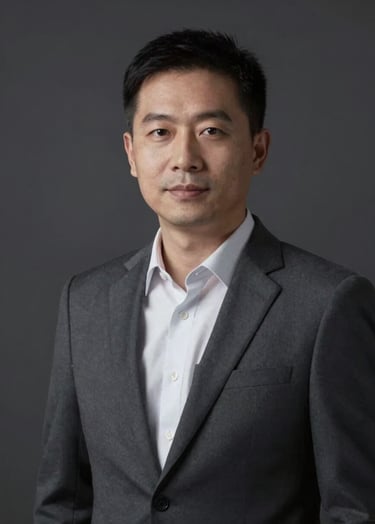 A professional portrait of an educator in a dark studio, lit by a single soft light source. The mood is intellectual and sophisticated, utilizing the #0A0A0A and #F8F8F8 palette.