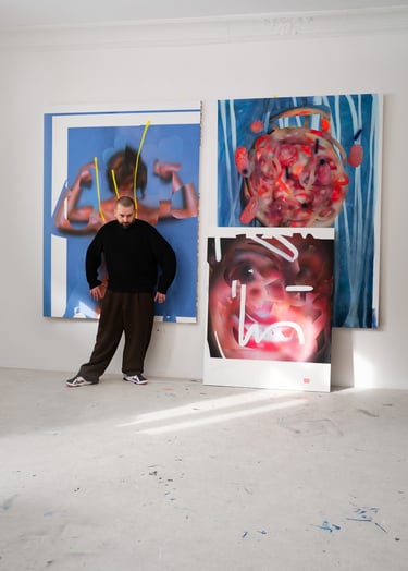 Artist Hadas Patryk standing in an art studio with large abstract oil paintings on white walls.