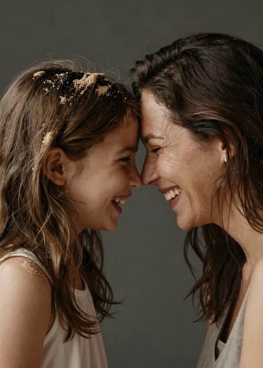 A portrait of a mother and daughter laughing, their foreheads touching. Soft, warm lighting from the side. Authentic emotional connection. High contrast with charcoal-toned backgrounds and soft sand highlights on their hair.