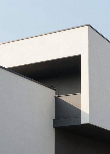 A full-screen style hero photograph of a minimalist architectural structure under a bright, clear sky. The building features stark off-white walls and deep charcoal shadows. High contrast, clean editorial feel, North American / Western European architecture.