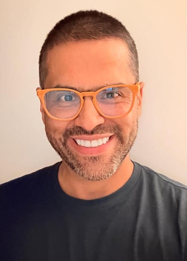 a man with glasses and a black shirt
