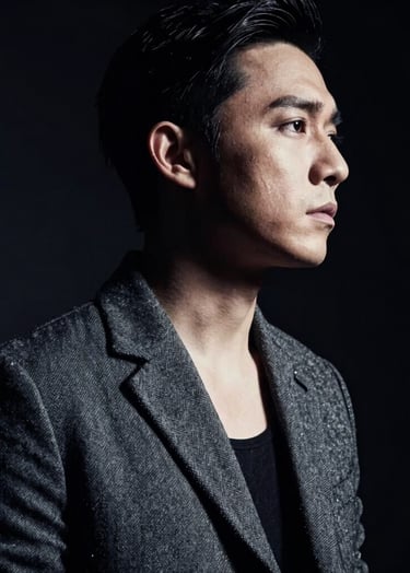 A close-up, low-key portrait of a musician in a stylish charcoal jacket, captured in a professional studio setting. Dramatic lighting creates deep black shadows and bright off-white highlights on their profile. Cinematic and moody North American / US music industry vibe.