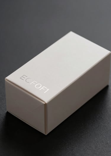 A minimalist, high-end packaging box for a skincare brand. The box is a matte #ECF0F1 off-white with subtle debossed silver lettering. It is placed on a sleek #0A1118 dark surface with soft, cinematic side lighting to emphasize the texture. Modern, sophisticated professional style.