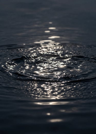 Macro photography of ripples in dark water, highlighting reflections of arctic mist and dusty steel light, deep obsidian depth, minimalist composition.