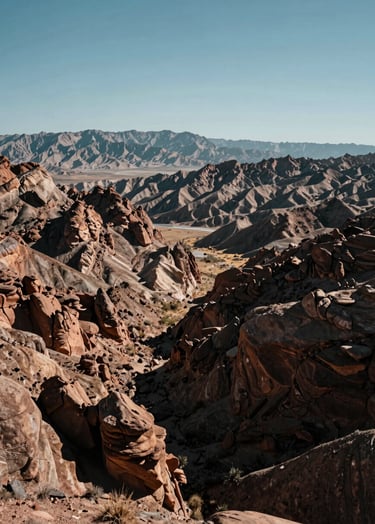 A high-resolution professional photograph of a vast, open valley in Northeast Nevada. The scene shows the Ruby Mountains in the distance, under a clear, bright sky. Rugged elegance with a focus on land potential and clarity.