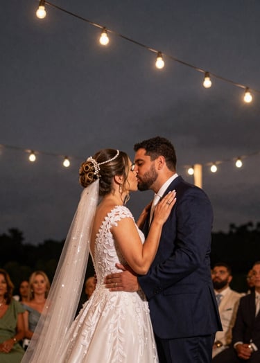 A cinematic and emotional candid shot of a Brazilian wedding ceremony at dusk. String lights twinkle in the background against a dark gray sky. Professional photography, artistic focus, deep black and warm light tones.