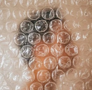 man behind bubble wrap blurred