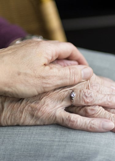 a woman holding a ring on her finger