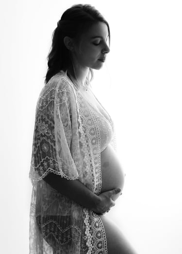 a pregnant woman in a white robe and a white robe