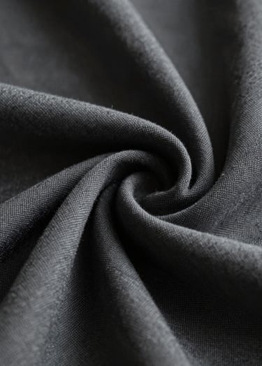 Close-up artistic shot of a high-quality textured fabric with elegant folds. The lighting is soft and moody, emphasizing the weave. The color palette includes #363636 and #B5A591. The background is a profound #000000, reflecting a premium visual experience.