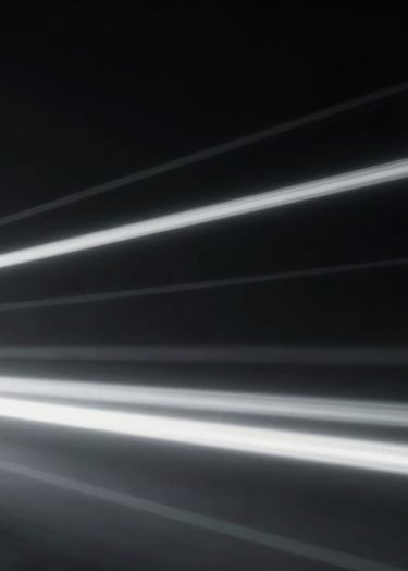 An abstract, sophisticated shot of blurred light trails against a dark void, mimicking motion, incorporating the brand colors #000000 and #363636 for a cinematic, minimalist effect.