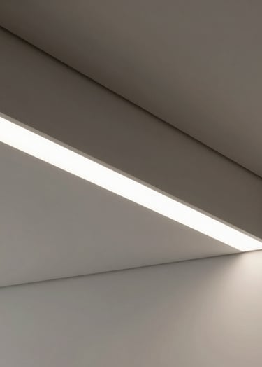 Detail of the minimalist interior lighting and ceiling structure. Clean lines and neutral tones of pale silver gray and off-white. Sophisticated shadows creating a sense of depth and innovative spatial solutions.