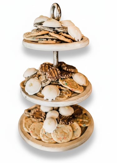 Assorted homemade cookies including iced tea cakes and chocolate chip on a tiered dessert stand