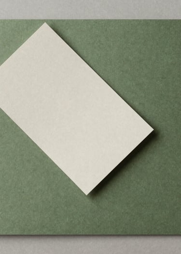 A top-down photograph of high-quality paper texture samples in shades of moss green and off-white. Minimalist composition on a neutral surface, soft natural lighting, South American studio aesthetic.