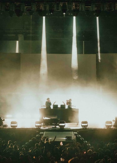 a man in a concert hall with a piano and a piano