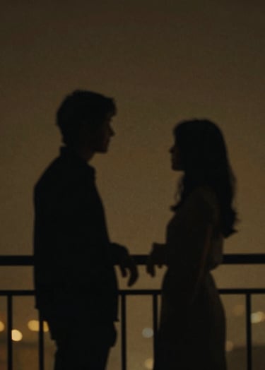 Film aesthetic, underexposed. A blurry silhouette of two people talking on a balcony at night. Minimalist composition, deep charcoal (#3E352B) and muted gold (#D1B499) hues. Atmospheric and emotional.