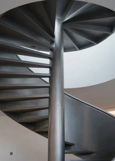An abstract upward shot of a modern spiral staircase in a professional office in Scandinavia. Minimalist aesthetic, utilizing silver and dark charcoal tones. Sophisticated architectural detail.