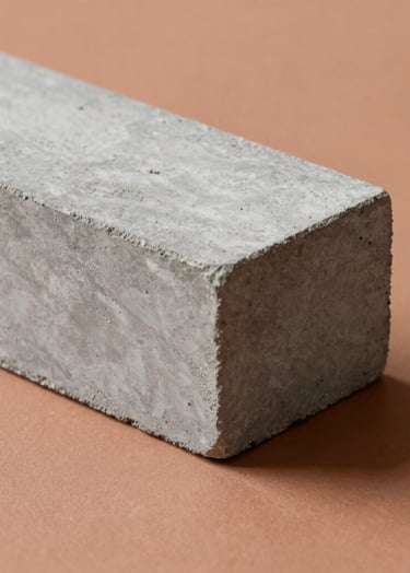 A minimalist close-up of high-end architectural materials: a block of raw grey concrete against a smooth, warm terracotta (#BC6C47) plane. Dramatic side-lighting creates deep shadows and emphasizes texture.