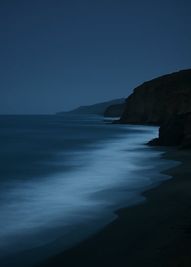 A serene coastal landscape in South America at dusk, where the dark navy sky meets the steel blue ocean, captured with professional long-exposure photography.