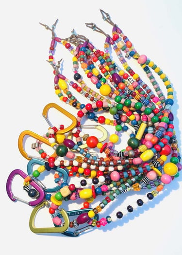 Handmade colorful beaded lanyards with metal carabiner clips for ID badges or keys.