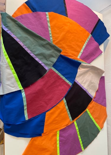 Handmade colorful patchwork fabric panels featuring vibrant geometric shapes for textile art projects.