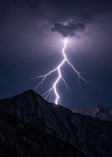 A sharp, high-contrast landscape photograph of a singular, brilliant lightning bolt striking a jagged mountain ridge at night. The sky is a deep navy, and the scene is illuminated by the electric flash. Minimalistic composition with clear, elegant lines. International / Western alpine setting.