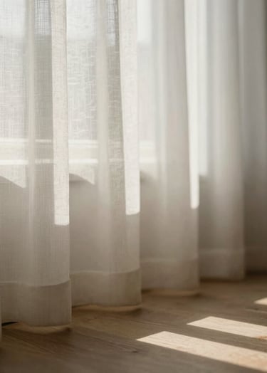 A preview of an upcoming lifestyle project. Soft morning light filtering through a sheer curtain onto a wooden floor. A subtle interplay of shadow and light #4C4A48. Fine art aesthetic, intimate and calm, using the brand's warm cream and grey tones.
