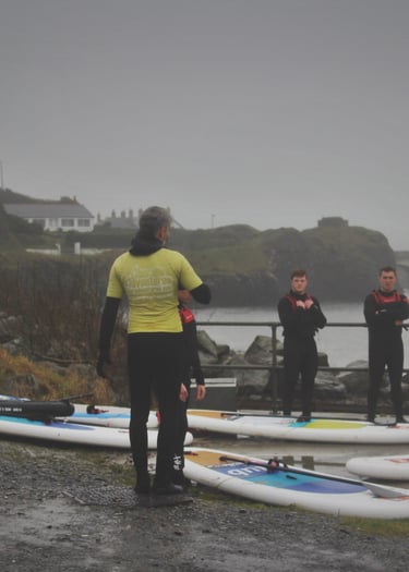 The rugby team getting intsruction from AberAdventures paddle board coaches
