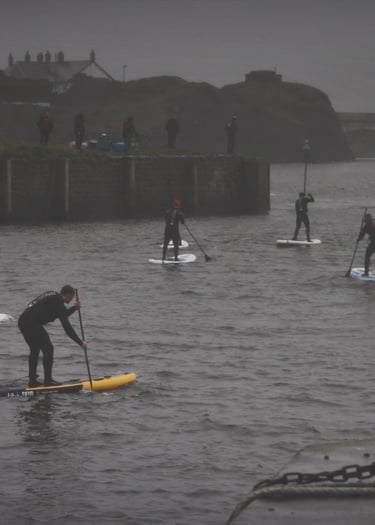 A paddle board race in Aberystwyth harbour on a grey December day
