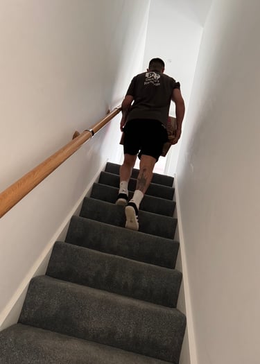 man carrying box up stairs